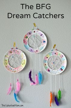 three colorful dream catchers hanging on the wall