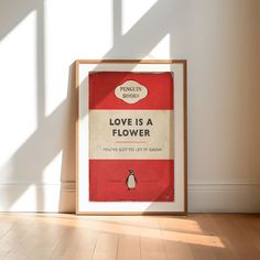 there is a poster on the wall with a penguin saying love is a flower you've got to do it right now