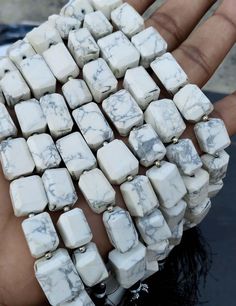 a hand that has some kind of white cubes on it's palm,