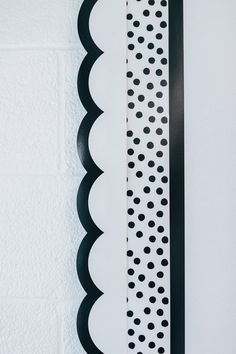 black and white scalloped paper hanging on the wall