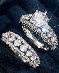 two wedding rings sitting on top of each other