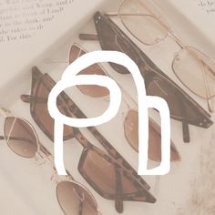 four pairs of glasses sitting next to each other on top of an open book with the word p