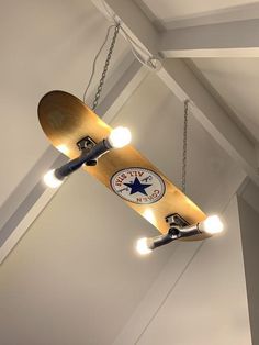 a skateboard suspended from the ceiling with lights