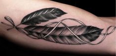 a black and white photo of a leaf tattoo