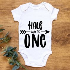 An adorable, handmade, funny baby grow/ baby bodysuit that reads 'Half Way To One' Our custom babysuits are made of 100% pure, soft and breathable cotton fabric, and are professionally printed using high quality heat transfer vinyl. Available sizes: 0-3, 3-6 months & 6-9 months Funny Short Sleeve Bodysuit For Birthday, Cute Unisex Bodysuit For Birthday, Playful White Bodysuit For First Birthday, Personalized Family Matching Onesie For Birthday, Playful Onesie With Letter Print For First Birthday, Playful Onesie With Name Print For First Birthday, Customizable Cute Birthday Bodysuit, Customizable Cute Bodysuit For Birthday, Playful First Birthday Onesie With Letter Print