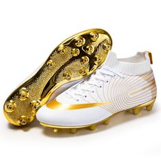 a pair of white and gold soccer shoes