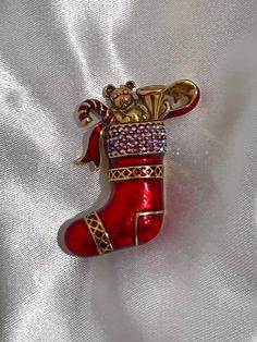 "Signed \"N\" used in 1940s-1950s for Napier. Sparking red AB rhinestone/crystals. Shiny, gold-toned metal and red enamel. Measurements:  2'' x 1''" Christmas Socks, Pin Brooch, Pin Badges, Christmas Stocking, Gold Tone Metal, Candy Cane, Crystal Rhinestone, Christmas Stockings, Brooch Pin