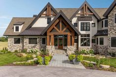 a large house with stone and wood accents