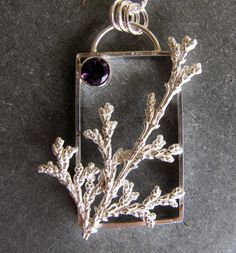 "Here is a handmade pendant made of sterling silver with an amethyst. I created a rectangular frame as the base of this pendant. I then cast a sprig of cypress from a tree in my yard. It is cast using a method like lost wax casting but in this cast it is lost plant casting. The plant material is burned away in my kiln leaving a cavity that is then filled with molten silver leaving an exact replica in solid sterling silver. A 6mm faceted amethyst is in the corner. The chain is sterling silver rou Lost Wax Casting Jewelry Pendants, Lost Wax Pendant, Wax Casting Jewelry, Lost Wax Casting Jewelry, Fused Jewelry, Wax Carving Jewelry, Texture Ideas, Silversmithing Jewelry, Jewelry Wax