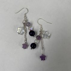 Amethyst and Crystal Star Dangle Earrings | Purple Star Earrings | Cute Accessory A cute pair of amethyst star dangle earrings for any occasion! Includes two earrings in a pair made just for you! Gift it to a friend or keep it for yourself. Perfect for the hard to gift for friend. :D Length : 2.5 inches  Make time : Will be made and shipped out within 1 - 3 days  Contact us with any issues and we will guarantee to make it right.  Handmade item by Audrey and Ruby from BugsandSlugsShop. Colors may vary slightly due to photo lighting. Check out our other products at BugsandSlugsShop and follow our instagram @bugsandslugsshop to keep updated on new listings and sales ! Purple Star Earrings, Star Bead Earrings, Purple Earrings Aesthetic, Purple Accessories Aesthetic, Whimsigoth Earrings, Bead Things, Purple Dangle Earrings, Star Dangle Earrings, Keychain Ideas