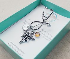 This unique keepsake brooch/pin is gorgeous in design and very unique! The stethoscope pin includes: -A PA Physician Assistant charm -An aluminum round disc stamped with your choice of initial (will NOT tarnish) -Your choice of birthstone Stethoscope pin measures 2.75 inches long with charms attached. Makes a great gift for upcoming graduation pinning ceremony or class graduation pins! Pin includes a FREE gift box! Titles available: RN, PA, PTA, PT, DPT, MA, CMA, MD, NP, RNP, LPN, LVN, DO, Rx, C Physician Assistant Gifts, Licensed Vocational Nurse, Pinning Ceremony Nurse, Gifts For Graduation, Medical Caduceus, Pinning Ceremony, Nurse Appreciation Week, Pa School, Thug Style