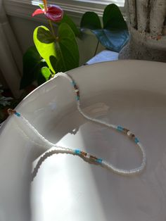 This is an original handmade glass beaded necklace. Will not tarnish. Colors: light blue, white, pearl, and light brown. Please message me with any questions. Everyday White Single Strand Beaded Necklace, White Beaded Necklaces With Tiny Beads For Everyday, White Beaded Necklaces With Round Beads For Everyday, Everyday White Beaded Necklaces With Tiny Beads, Everyday White Beaded Necklaces With Round Beads, White Single Strand Beaded Necklace As Gift, White Beaded Necklaces For Everyday, Everyday White Beaded Necklace With Tiny Beads, White Handmade Beads