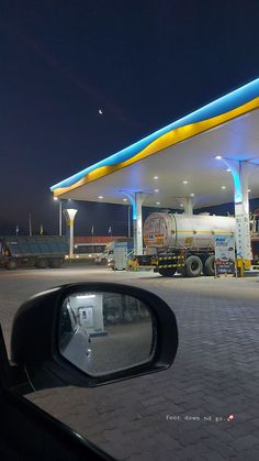 a gas station is lit up at night