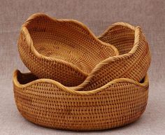 two woven baskets sitting on top of each other