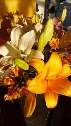 a vase filled with yellow and white flowers