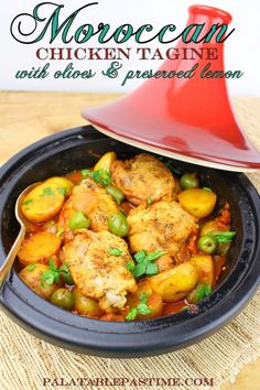 moroccan chicken tagine with potatoes and green lemons in a black bowl on a wooden table