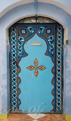 a blue door with an ornate design on it