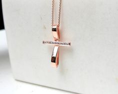 This artistic design cross pendant is made of solid gold and decorated with natural diamonds. It contains 8-10 round brilliant cut diamonds. You can choose 14K or 18K yelllow, white or rose gold. A modern cross for women which is not only a christian symbol but also a beautiful piece of jewelry. A meaningful gift for you and your loved ones. A dainty cross which is distinguished for its modern design. DETAILS oMaterials ⁃ 14K or 18K gold         Yellow, White or Rose Gold   oHeight ⁃ 2.4mm / 0.9 Cross Necklace With Pave Setting As Gift, Cross Necklace With Pave Setting For Gift, Pave Setting Cross Necklace For Gift, Anniversary Diamond Pendant Cross Necklace, Diamond Cross Pendant Necklace With Pave Setting, Diamond Cross Pendant Necklace With Pave Setting For Gift, Gift Diamond Necklace With Pave Setting And Cross Pendant, Pave Setting Diamond Cross Pendant Necklace As Gift, Gift Cross Necklace With Diamond Accents