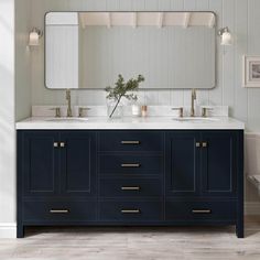 a bathroom vanity with two sinks and a large mirror above it, all in dark blue