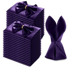 a stack of purple napkins with a bow tie on top of each one in front of it