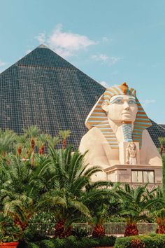 the sphinx statue in front of the pyramid at the entrance to the egyptian museum, with palm trees around it