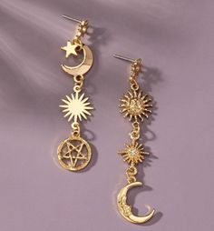 Add a celestial touch to your ensemble with these Mismatched Sun, Moon, and Star Linear Drop Post Earrings. This unique set features a pair of earrings with an enchanting combination of various charms, including the sun, moon, and star, all aligned in a linear design. These mismatched earrings offer a whimsical twist, perfect for those who love to stand out with a touch of cosmic charm. Each charm is delicately adorned with glass rhinestones, adding a subtle sparkle that catches the light from e Mystical Gold Earrings With Sun And Moon Design, Celestial Moon Earrings With Star Charm, Celestial Moon Shaped Earrings With Star Charm, Celestial Moon-shaped Earrings With Star Charm, Celestial Sun And Moon Dangle Jewelry, Celestial Star Shaped Earrings With Sun And Moon Design, Celestial Star-shaped Earrings With Sun And Moon Design, Gold Celestial Earrings With Sun And Moon Design, Symbolic Sun And Moon Star Jewelry