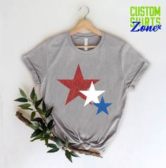 "4th of July womens Shirt,USA Star Shirt,4th of July Shirt,4th of July Red White Blue Stars,patriotic shirt,Independence Day,USA Star Tee 🎁 Enjoy your shopping ! Need custom made shirts? Don't hesitate to message us! Thanks for your support! CustomShirtsZone_ Family ----- How To Order ----- 1-) Please, check and review all the photos. 2-) Choose your t-shirt size and color. *Different styles of shirts may have different shades of same color choice due to different manufacturer brands. *For this Patriotic American Flag Print Tops For 4th Of July, Patriotic Red Tops For Veterans Day, Red Patriotic Tops For Veterans Day, Red Patriotic Tops, Red Tops With American Flag For Independence Day, Red American Flag Top For Independence Day, Patriotic Short Sleeve T-shirt With Star Print, Americana Shirt With American Flag Print For Memorial Day, Patriotic Star Print Short Sleeve T-shirt