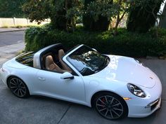 a white sports car is parked on the street