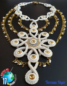 an elaborate necklace made with pearls and gold