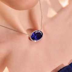 This 25.50 carat oval cut tanzanite sparkles and shines as it's set in 18 karat white gold, surrounded by 0.69 total carats of round brilliant cut diamonds. Reference Code: 30703 Shop other beautiful pieces in our Necklace Collection. For inquiries on the piece please contact: boutique@shsilver.com Luxury Oval Tanzanite Jewelry, Luxury Oval Tanzanite Necklaces, Paris Ring, Tanzanite Necklace, Tanzanite Jewelry, Halo Necklace, Jewelry Appraisal, Necklace Collection, Diamond Halo