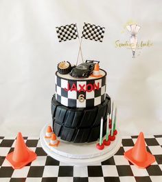 a black and white cake sitting on top of a checkered table