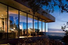 a house with large glass windows overlooking the city