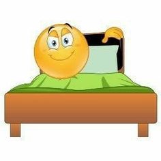 an emoticive smiley face laying on a bed with green sheets and pillows in front of it