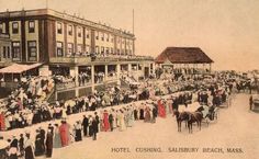 an old photo of people standing in front of a building with horses and carriages on the street