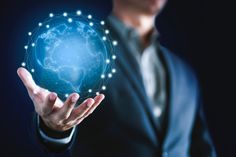 a man in a suit holding up a glowing globe