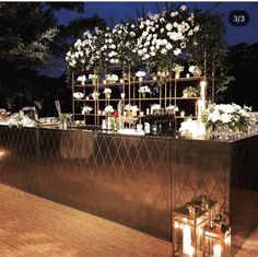 an outdoor bar decorated with flowers and candles