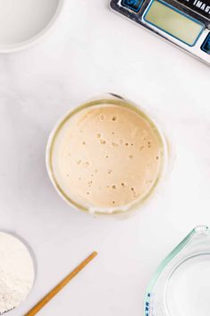 the ingredients to make this smoothie are in bowls, measuring cups and spoons