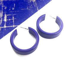 Cobalt Blue opaque lucite hoop earrings in a straight & sturdy shape with a shiny cobalt finish anda purple hue. This style is known as the 'Chandler Hoop' (formerly known as the Small Portland Hoop) and comes in 2 sizes. The larger one is the Portland Hoop. This is the smaller of the 2, but is in no way a small hoop. It measures about 30mm or 1.25" in diameter & 10mm in width. One of our favorite styles & comes in many colors. Jewelry is designed & hand finished by us, here in t Modern Plastic Hoop Earrings For Gifts, Modern Plastic Hoop Earrings As Gift, Modern Small Hoop Plastic Earrings, Trendy Plastic Hoop Earrings, Trendy Small Hoop Plastic Earrings, Modern Plastic Hoop Earrings, Modern Small Hoop Earrings In Plastic, Modern Small Hoop Plastic Jewelry, Modern Plastic Hoop Jewelry