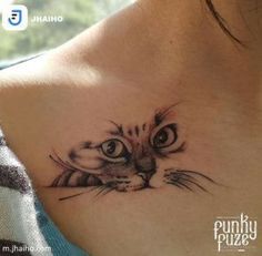 a woman with a cat tattoo on her chest