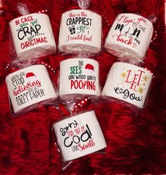 six mugs are wrapped in plastic on a red blanket