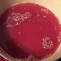 a pot filled with liquid on top of a stove