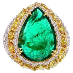 Introducing this GRS Certified 4.95 Carat Zambian Emerald and Diamond Ring, a one-of-a-kind creation that embodies sophistication and exceptional craftsmanship. The centerpiece of this remarkable piece is a 4.95-carat pear-shaped emerald, sourced from the renowned mines of Zambia. Certified by GemResearch SwissLab (GRS) and displaying a natural, untreated beauty with insignificant treatment, this emerald captivates with its deep, rich green hue—an exquisite testament to its origin. What truly makes this ring unique is its innovative design, carefully crafted to highlight the emerald’s elegance. Surrounding the center stone is an intricate arrangement of 4.45 carats of round and fancy-cut diamonds, each precisely placed to enhance the emerald’s natural beauty. The combination of diamond sha Fancy Diamond Ring, Emerald And Diamond Ring, Zambian Emerald, Fancy Diamonds, Ring Unique, Belleza Natural, Zambia, Custom Engraving, Cocktail Rings