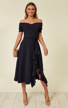 This off-shoulder navy dress is a classic and sophisticated choice for a fall wedding. The off-shoulder neckline and asymmetrical ruffle detail add a modern twist to the traditional silhouette. The midi length and fitted waistline create a flattering and elegant look, perfect for both formal and semi-formal weddings. Pair it with red accessories and nude heels for a chic and polished ensemble.  Photo credit by: silkfred.com Wedding Guest Outfits Uk, Navy Wedding Guest Dresses, Wedding Guest Dresses Uk, Blue Wedding Guest Dresses, Midi Wedding Guest Dress, Easter Dress Toddler, Midi Dress Wedding, Midi Dress Wedding Guest, Summer Wedding Guest Dress