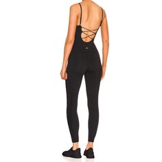 Lezat Jumpsuit Lorna Criss-Cross Organic Cotton Jumpsuit - Black Fitted Elastane Bodysuit For Yoga, Black Elastane Unitard For Athleisure, Black Elastane Athleisure Unitard, Seamless Second-skin Activewear For Sports, Compressive Elastane Bodysuit For Yoga, Black Elastane Unitard For Gym, Seamless Second-skin Activewear For Yoga, Functional Second-skin Activewear For Gym, Second-skin Functional Activewear For Gym