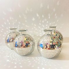 two shiny vases with mirrors on them