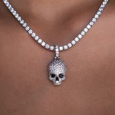 Introducing the Iced Black Stone Skull Pendant, intricately designed and crafted to perfection. This eye catching piece features a fully iced out skull head decorated with black hand-set stones. Micro-sized yet bold, wear this pendant on our 3mm Diamond Tennis Necklace for an edgy look that is sure to shine! This product is guaranteed for life - GLD will repair the item should you experience any defects in craftsmanship or breakage. Specifications - 14mm x 22mm (Width x Height) - Weight: (Weight Diamond Skull, Diamond Tennis Necklace, Diamond Eyes, Skull Head, Skull Necklace, Skull Pendant, Vermeil Jewelry, Tennis Necklace, Custom Earrings