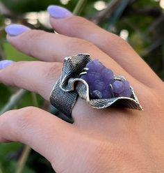 Handmade silver ring with natural grape agate. This stone is also known as grape chalcedony. A big large ring with beautiful purple agate stone. Unusual design ring from the Shahinian family. Made in Armenia.  If you are fond of unusual and unique design jewelry, this ring can be a great idea.  ⦿We can also make matching earrings, pendants, and bracelets. For more details, just write to me. All our jewelry is crafted with great attention to detail! We strive to provide you with the best quality, modern design, and perfect look!! All our jewelry is made of high-quality sterling silver and is stamped with a 925 stamp ◦* ◦* ◦* ◦* ◦* ◦* ◦* ◦* ◦* ◦* ◦* ◦* 【FULL DETAILS】 ► Gemstone: Grape agate  ► RING size: all sizes are available (choose from the option) ► Weight: approx. 20 gr More from us Fo Modern Silver Ring, Ring With Stone, Grape Agate, Big Stone Ring, Ring Purple, Chalcedony Ring, Purple Agate, Unusual Jewelry, Textured Ring