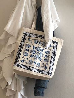 a tote bag hanging up against a wall with ruffles on the bottom