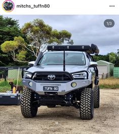 an off road vehicle parked on top of a dirt field