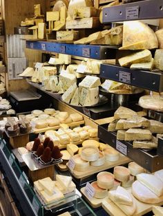 several different types of cheese on display in a store